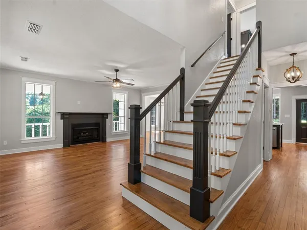 a view of entryway and hall with wooden floor