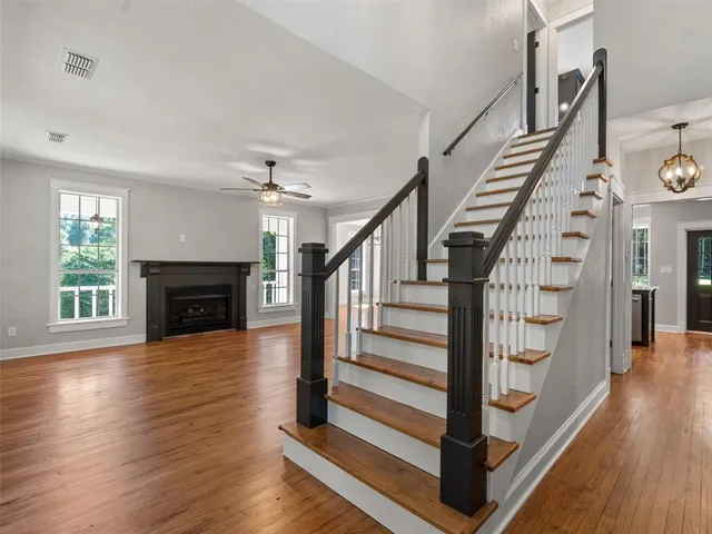 a view of entryway and hall with wooden floor