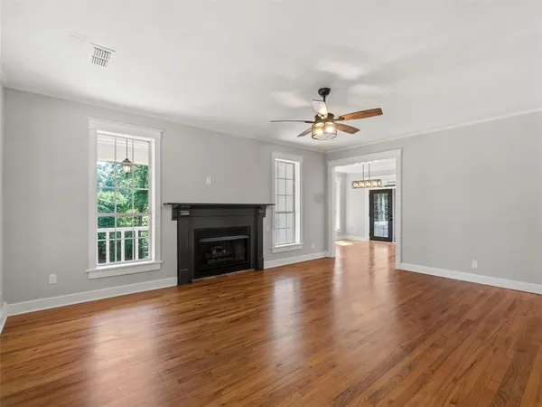 a view of livingroom with fireplace window and wooden floor
