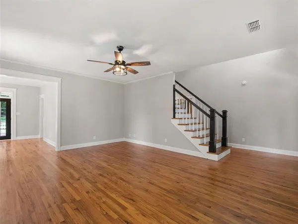 a view of an empty room with wooden floor