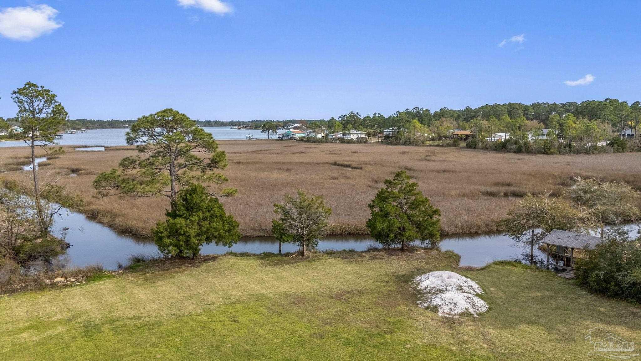 7524 Petersen Point Road Milton, FL 32583 - Photo 22 of 26 a view of a lake from a yard