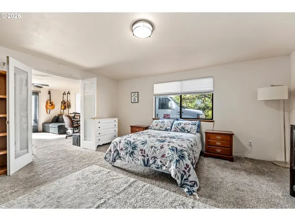 a bedroom with a bed and a window