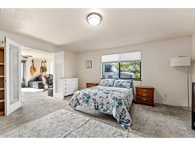 a bedroom with a bed and a window