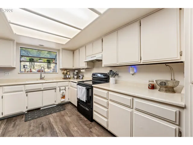 a kitchen with sink cabinets and window