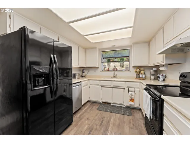a kitchen with a sink stove and refrigerator