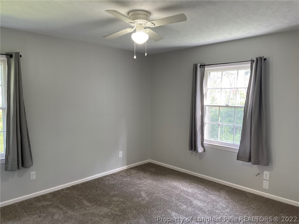 1714 Valley Ridge Drive Fayetteville, NC 28303 - Photo 13 of 32 an empty room with windows and fan