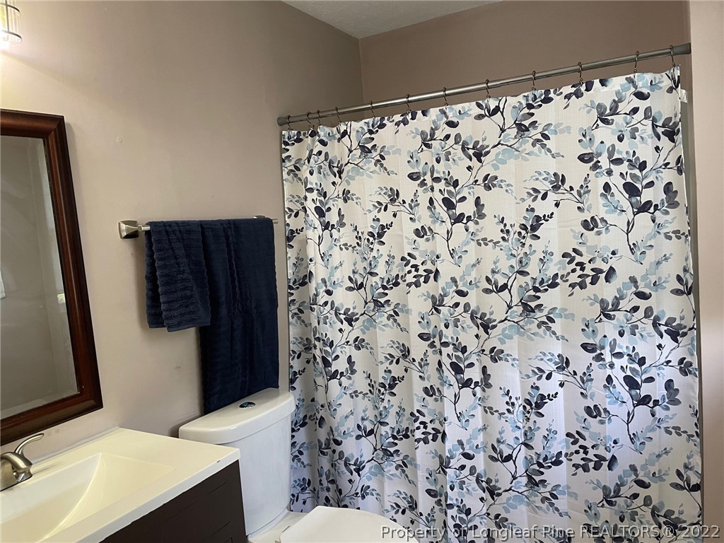 1714 Valley Ridge Drive Fayetteville, NC 28303 - Photo 15 of 32 a bathroom with a sink and a mirror