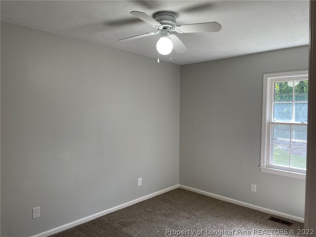 1714 Valley Ridge Drive Fayetteville, NC 28303 - Photo 17 of 32 an empty room with windows and fan
