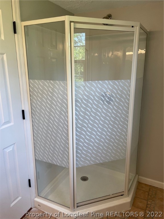 1714 Valley Ridge Drive Fayetteville, NC 28303 - Photo 25 of 32 a bathroom with a glass shower door