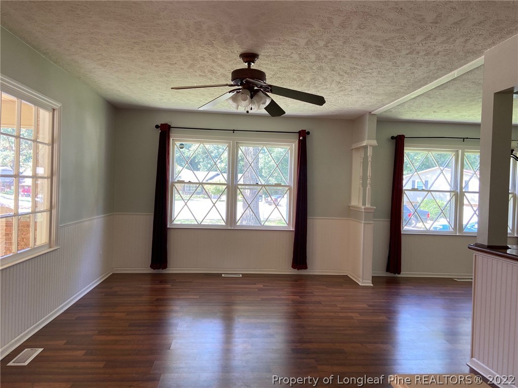 1714 Valley Ridge Drive Fayetteville, NC 28303 - Photo 6 of 32 an empty room with wooden floor chandelier and windows