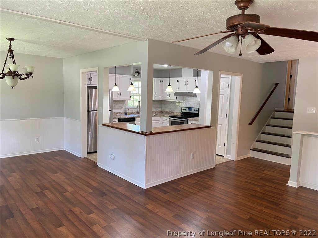 1714 Valley Ridge Drive Fayetteville, NC 28303 - Photo 8 of 32 a kitchen with stainless steel appliances kitchen island a refrigerator and a wooden floor