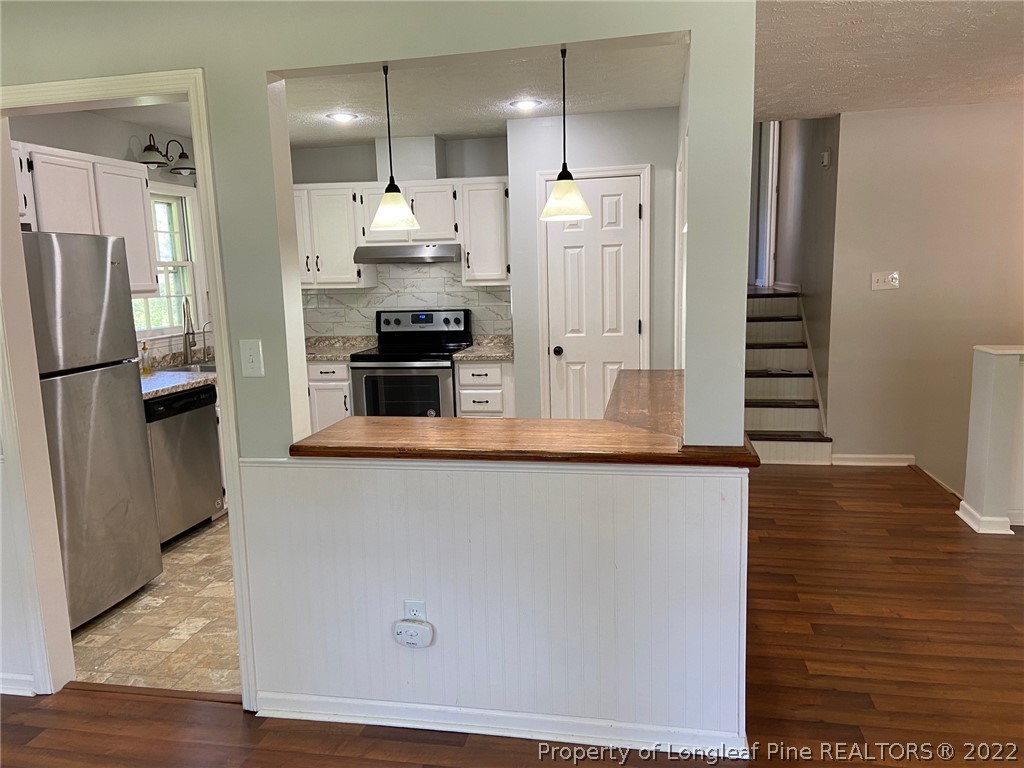 1714 Valley Ridge Drive Fayetteville, NC 28303 - Photo 9 of 32 a kitchen with stainless steel appliances a refrigerator and a stove top oven