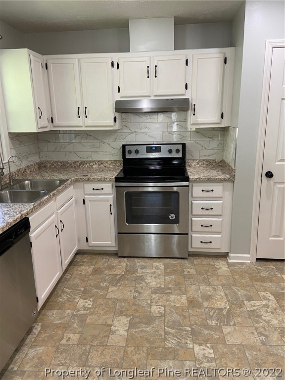 1714 Valley Ridge Drive Fayetteville, NC 28303 - Photo 10 of 32 a kitchen with granite countertop a stove microwave and cabinets