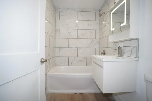 a white bath tub sitting next to a white sink