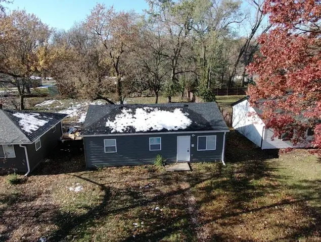 a view of a house with a yard and sitting area