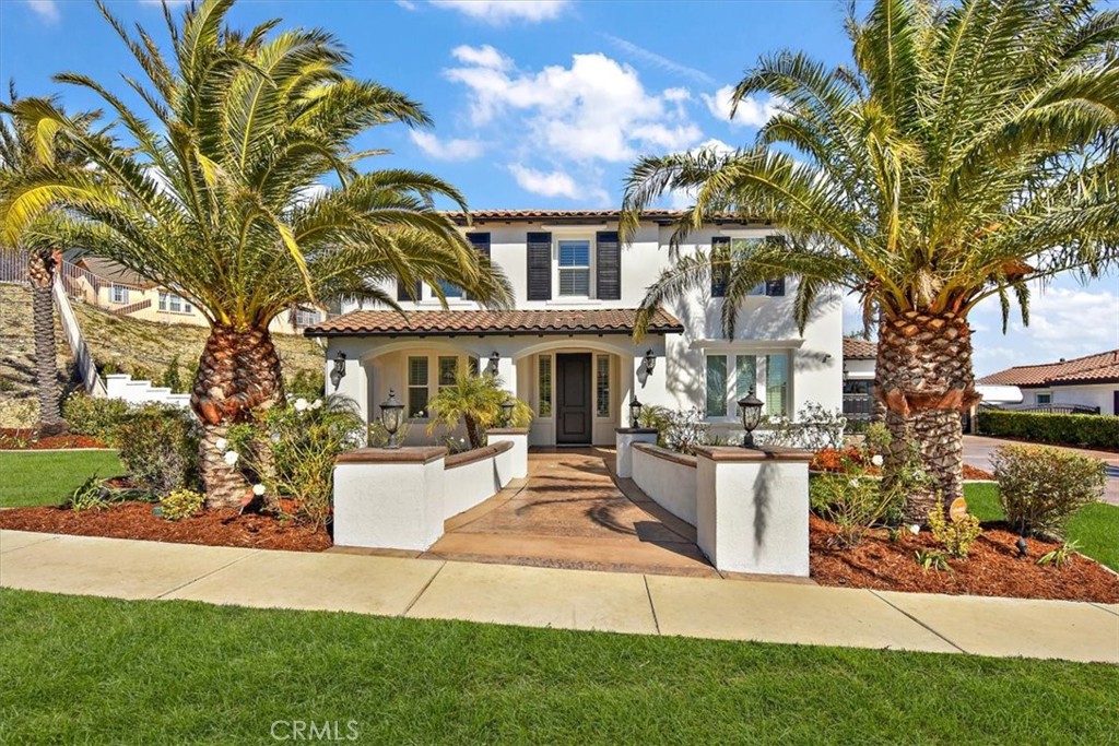 5035 Sagewood Drive Rancho Cucamonga, CA 91739 - Photo 1 of 1 a front view of a house with a garden and trees