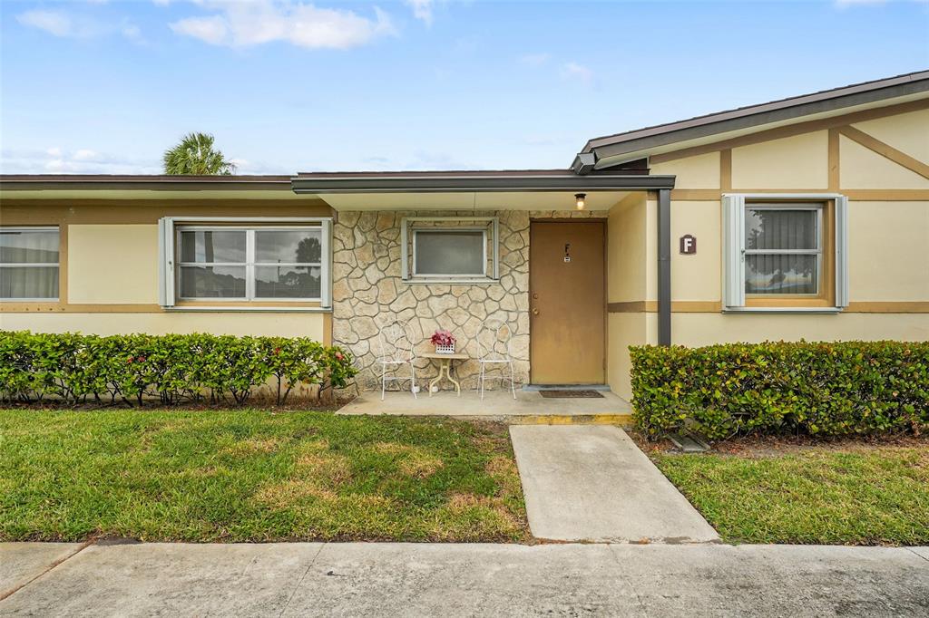 2769 Ashley Drive West, Unit F West Palm Beach, FL 33415 - Photo 1 of 25 front view of a house with a yard