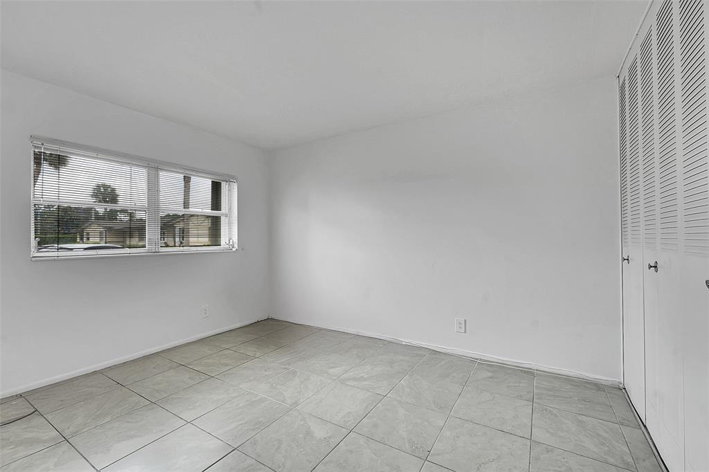 2769 Ashley Drive West, Unit F West Palm Beach, FL 33415 - Photo 12 of 25 a view of an empty room with a window