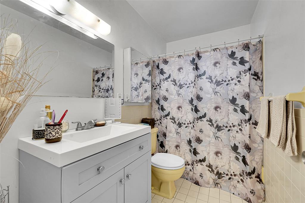 2769 Ashley Drive West, Unit F West Palm Beach, FL 33415 - Photo 14 of 25 a bathroom with a sink toilet and shower