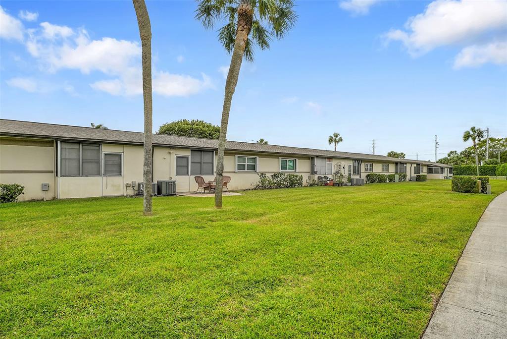 2769 Ashley Drive West, Unit F West Palm Beach, FL 33415 - Photo 18 of 25 a front view of a house with garden