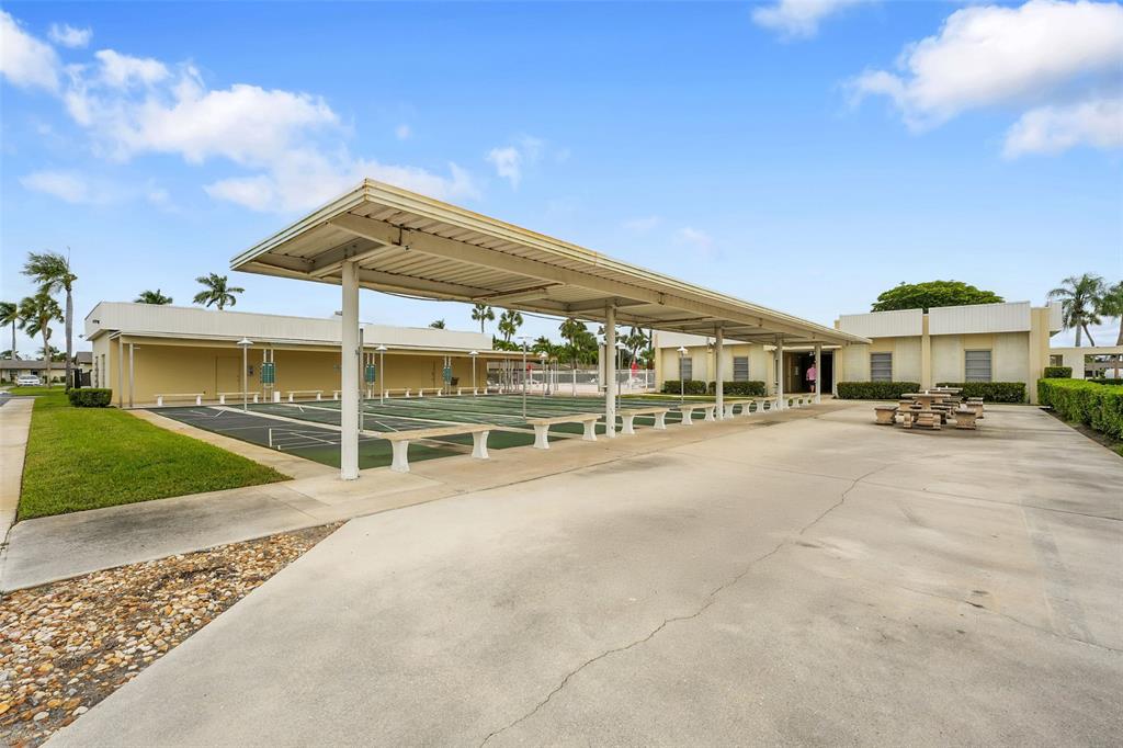 2769 Ashley Drive West, Unit F West Palm Beach, FL 33415 - Photo 23 of 25 a view of house with outdoor space and porch
