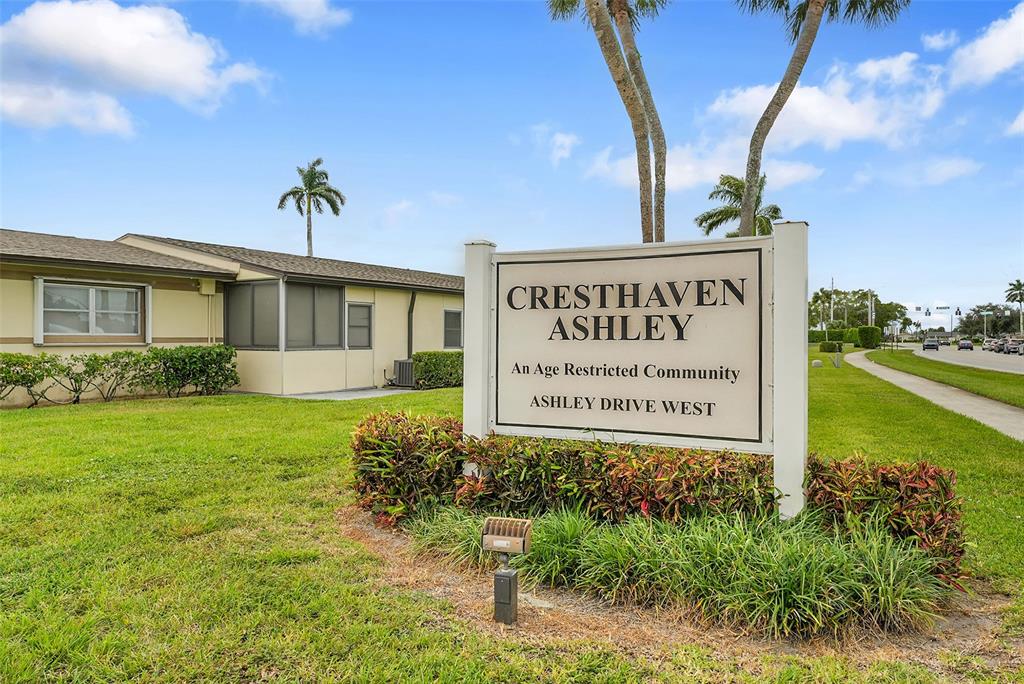 2769 Ashley Drive West, Unit F West Palm Beach, FL 33415 - Photo 25 of 25 a sign on the side of the building