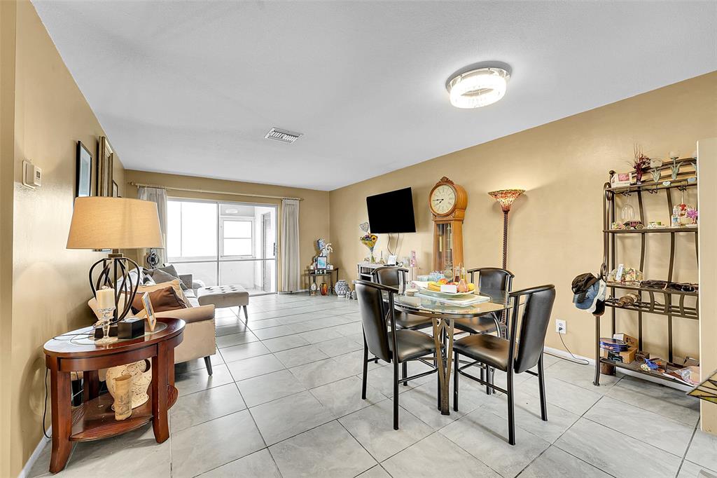 2769 Ashley Drive West, Unit F West Palm Beach, FL 33415 - Photo 3 of 25 a view of a dining room with furniture window and outside view