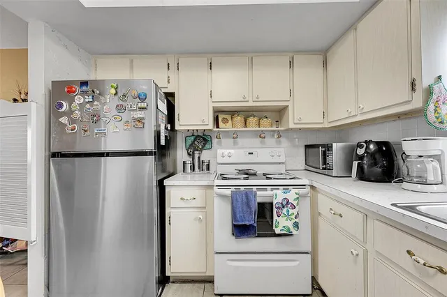 a kitchen with stainless steel appliances granite countertop a refrigerator sink and cabinets