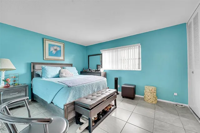 a bedroom with a bed and a lamp on desk