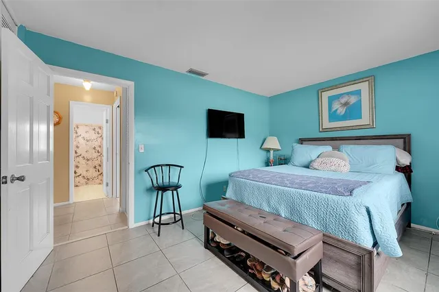 a bedroom with furniture and a painting