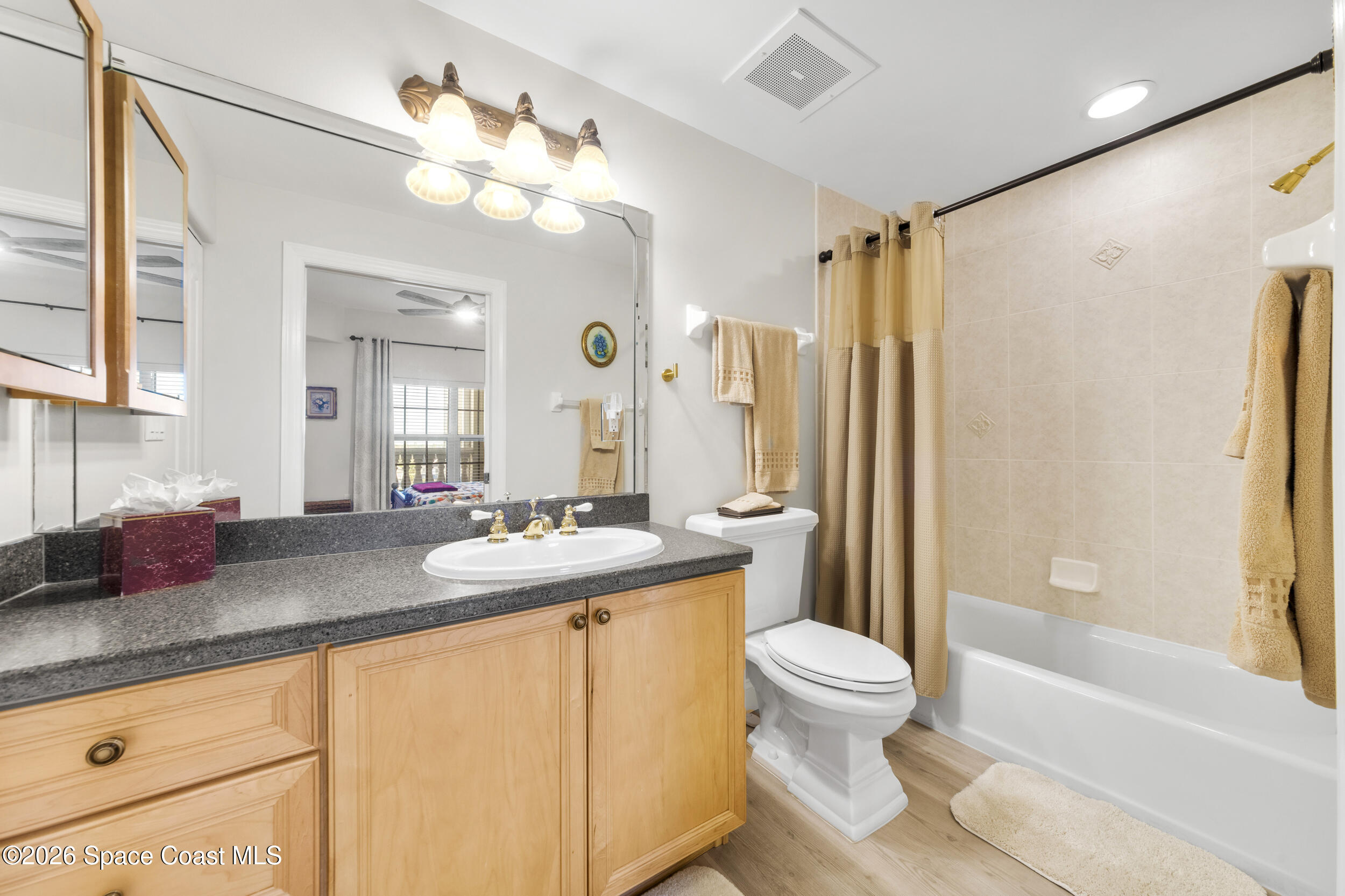 4955 Dixie Highway Northeast, Unit 702 Palm Bay, FL 32905 - Photo 11 of 54 a bathroom with a granite countertop sink toilet and shower