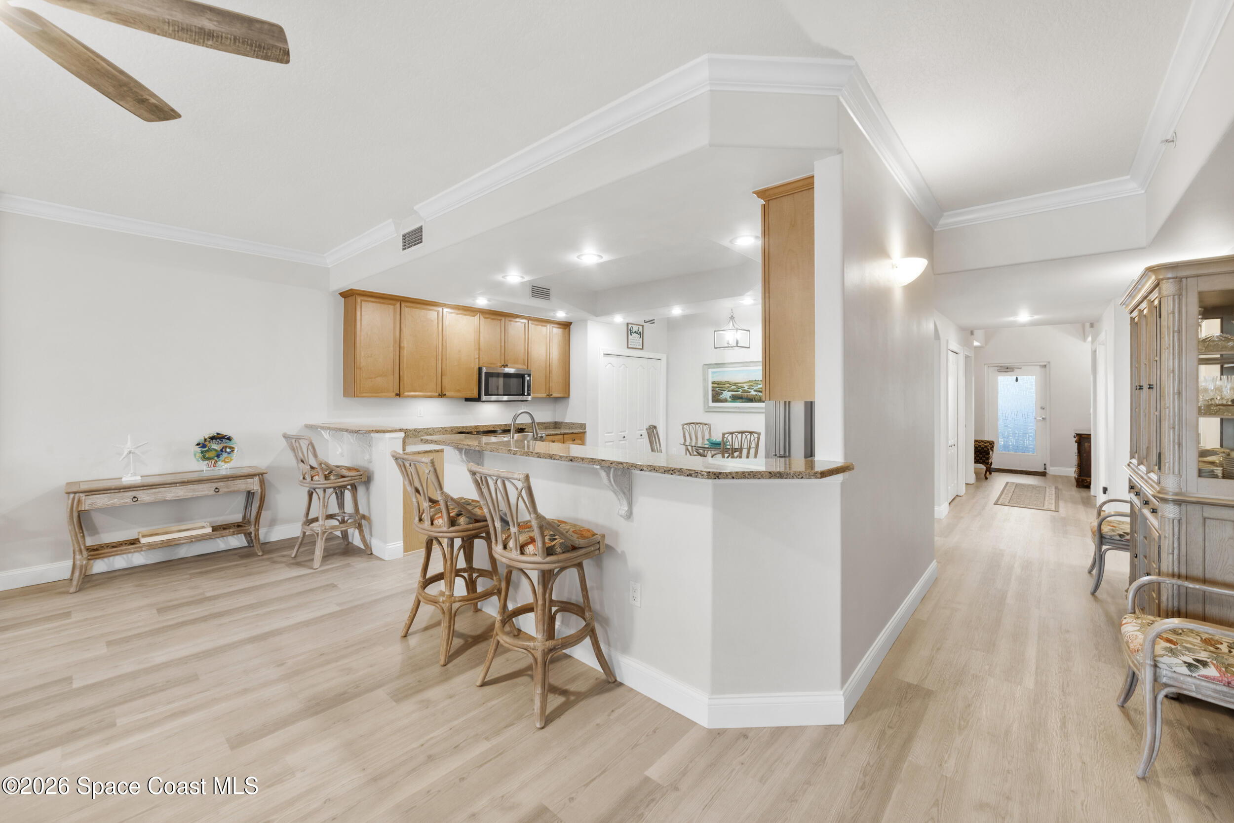 4955 Dixie Highway Northeast, Unit 702 Palm Bay, FL 32905 - Photo 19 of 54 a view of a dining room kitchen with furniture and wooden floor