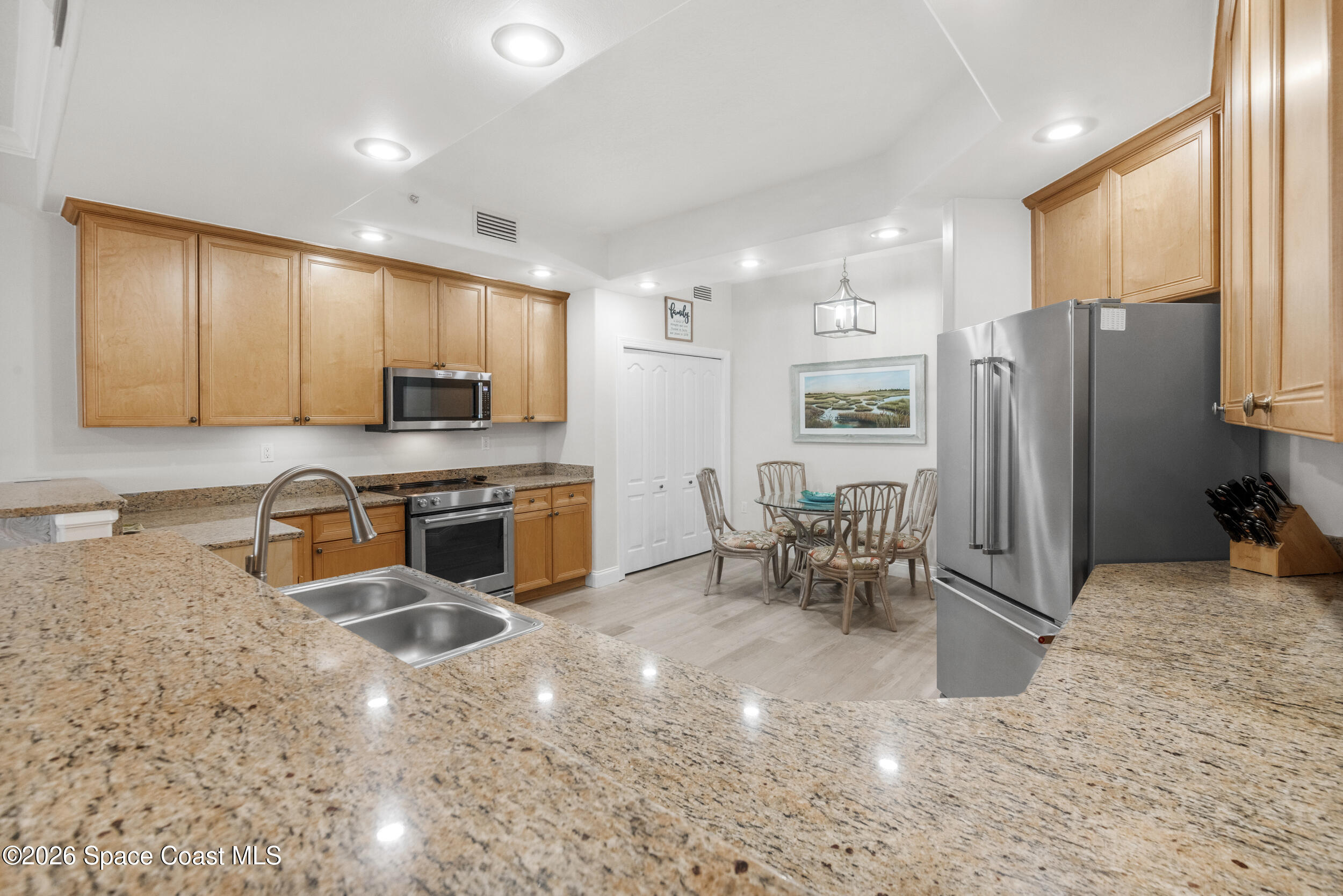 4955 Dixie Highway Northeast, Unit 702 Palm Bay, FL 32905 - Photo 21 of 54 a kitchen with stainless steel appliances granite countertop a refrigerator and a stove top oven