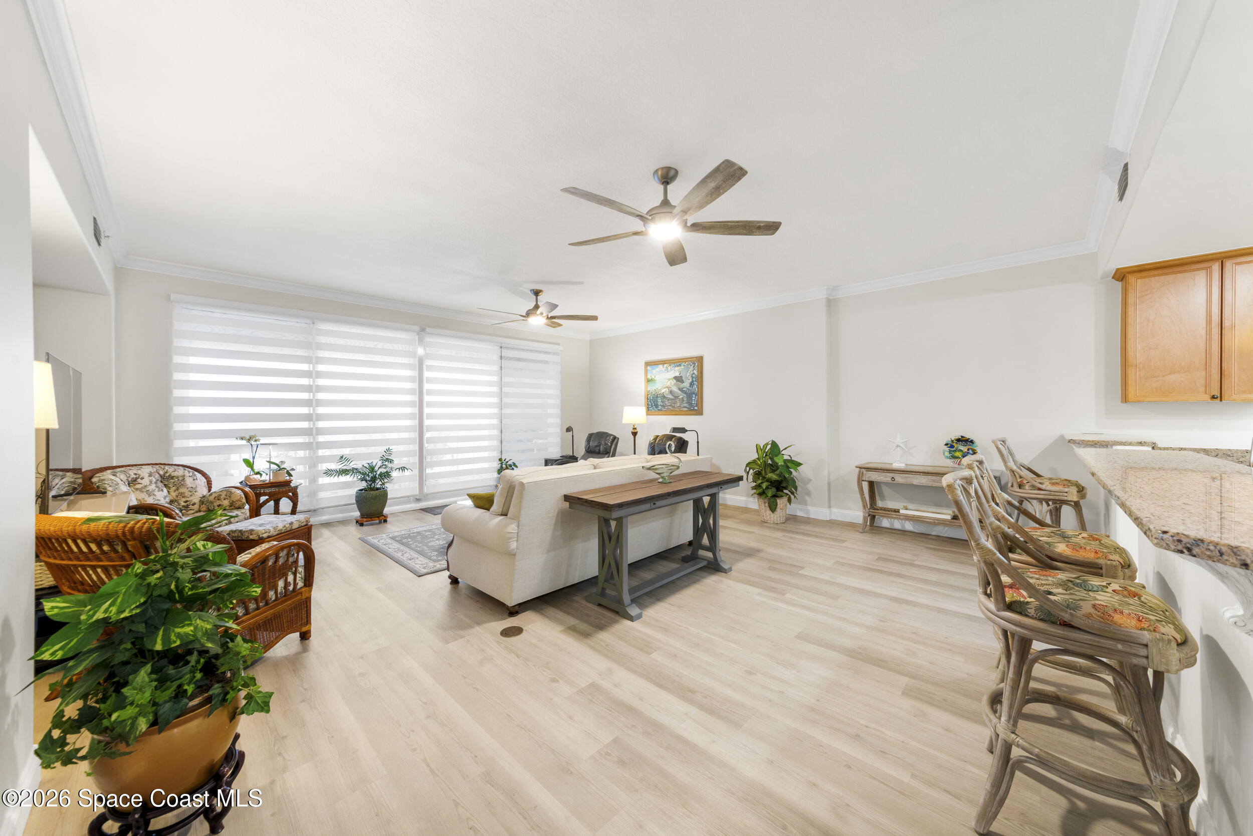 4955 Dixie Highway Northeast, Unit 702 Palm Bay, FL 32905 - Photo 25 of 54 a living room with furniture ceiling fan and a window
