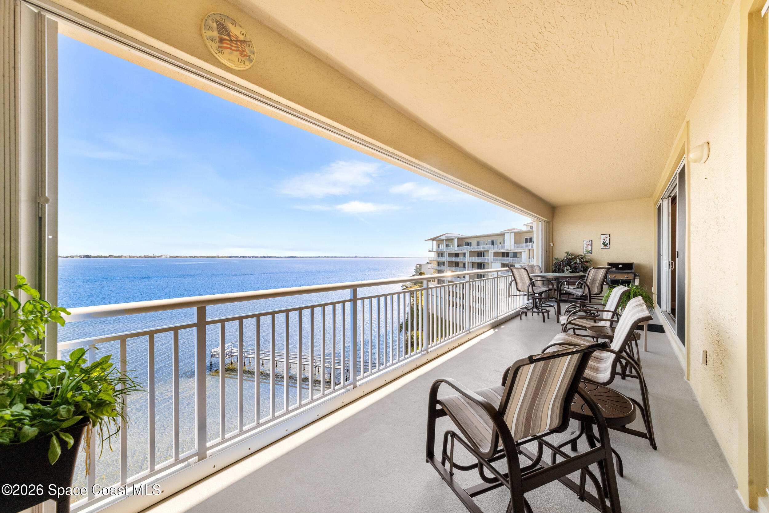 4955 Dixie Highway Northeast, Unit 702 Palm Bay, FL 32905 - Photo 28 of 54 a view of a chairs and tables in the balcony