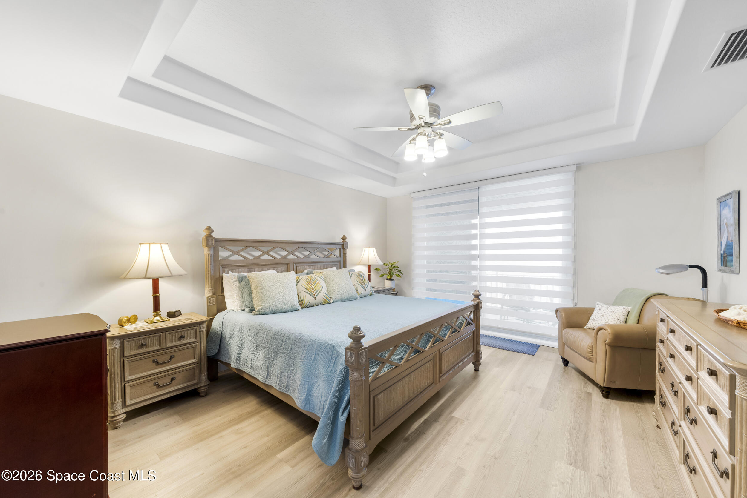 4955 Dixie Highway Northeast, Unit 702 Palm Bay, FL 32905 - Photo 32 of 54 a bedroom with a bed next to a window and a lamp