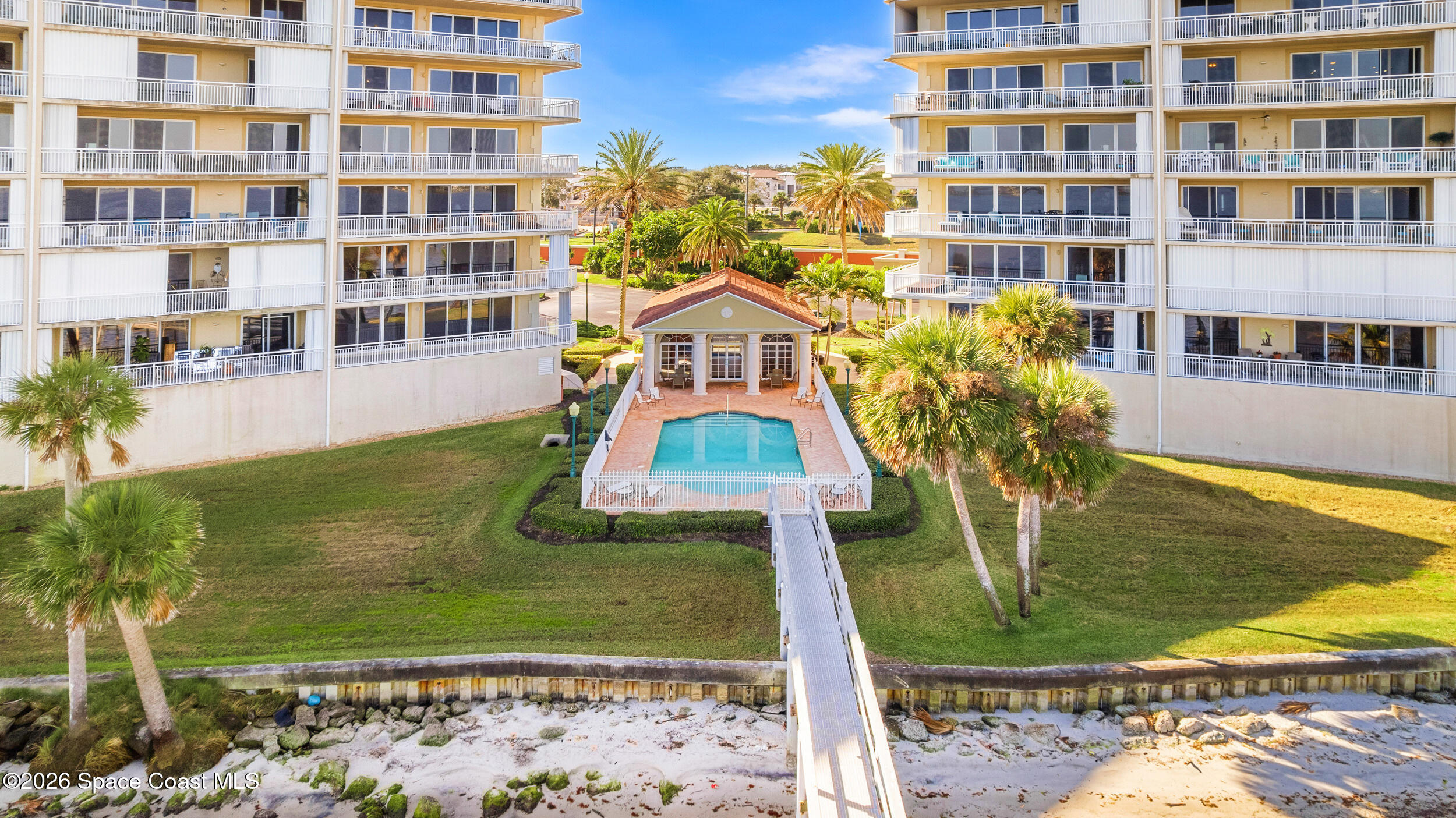 4955 Dixie Highway Northeast, Unit 702 Palm Bay, FL 32905 - Photo 39 of 54 a front view of a multi story residential apartment building with yard