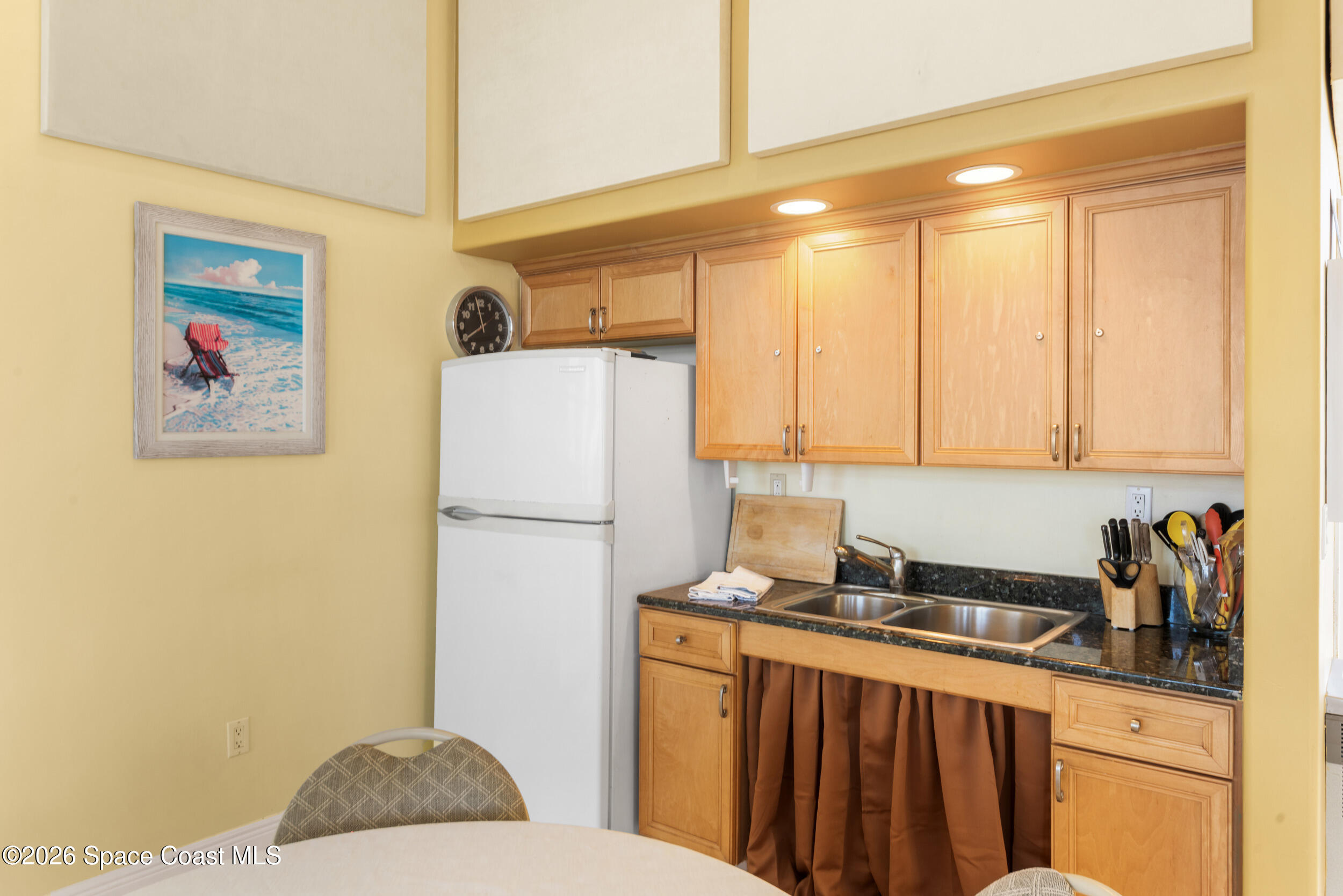 4955 Dixie Highway Northeast, Unit 702 Palm Bay, FL 32905 - Photo 42 of 54 a kitchen with a refrigerator and a sink