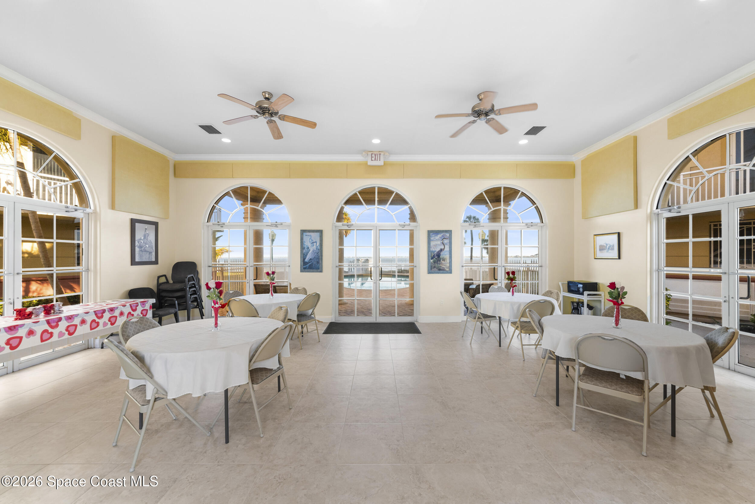 4955 Dixie Highway Northeast, Unit 702 Palm Bay, FL 32905 - Photo 43 of 54 a living room with couches and a dining table with wooden floor