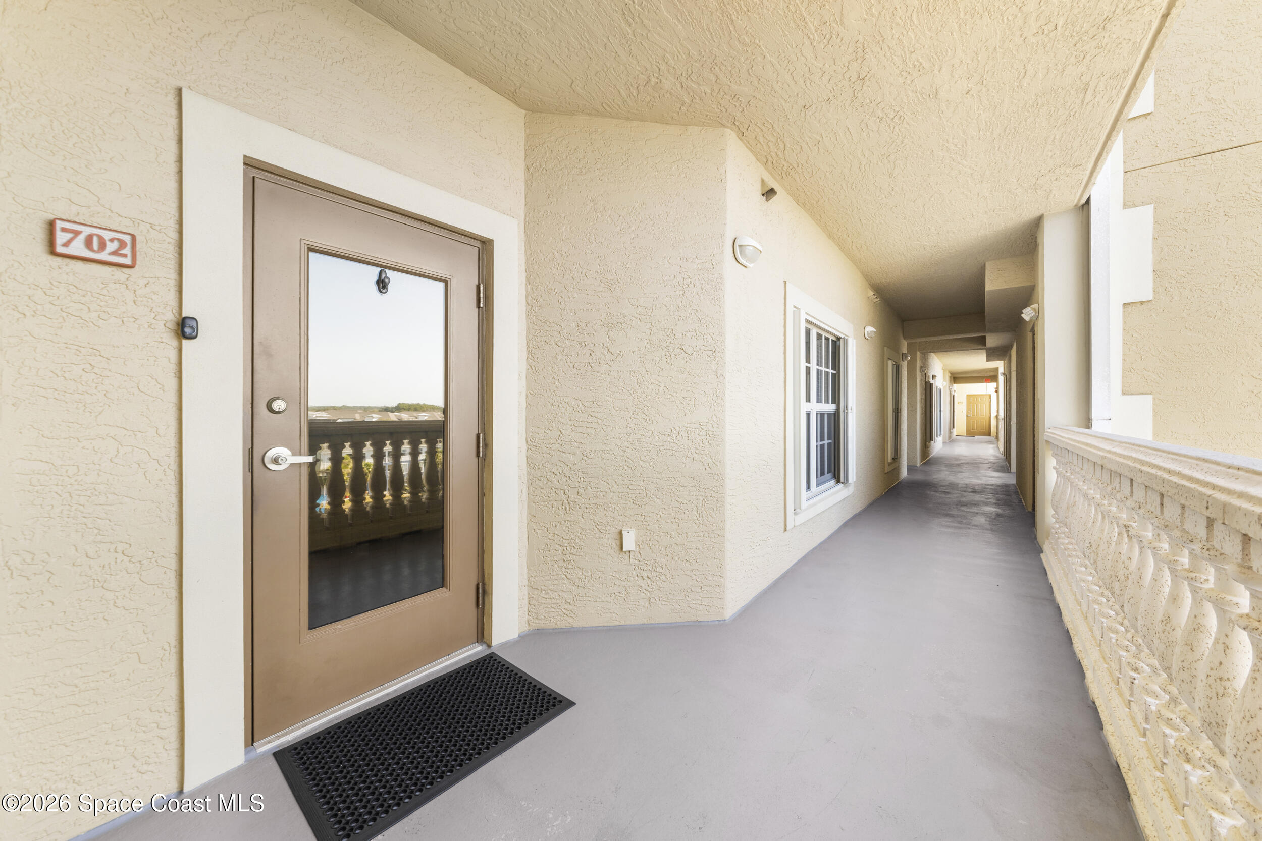 4955 Dixie Highway Northeast, Unit 702 Palm Bay, FL 32905 - Photo 7 of 54 a view of a hallway with wooden floor and a living room