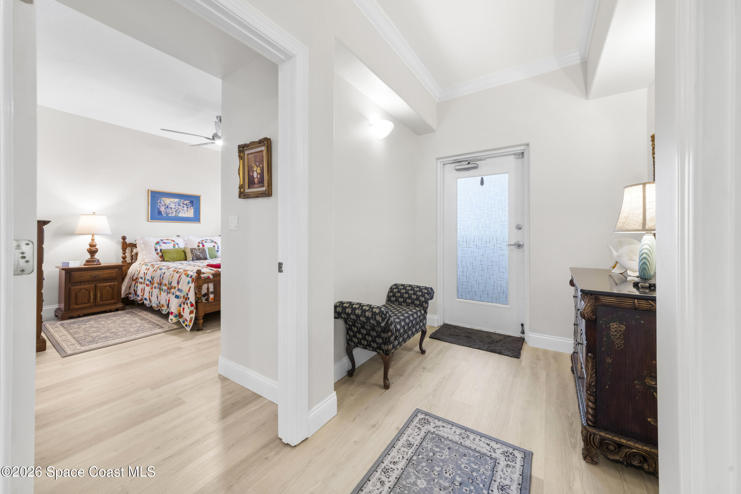 4955 Dixie Highway Northeast, Unit 702 Palm Bay, FL 32905 - Photo 8 of 54 a bedroom with furniture and a mirror