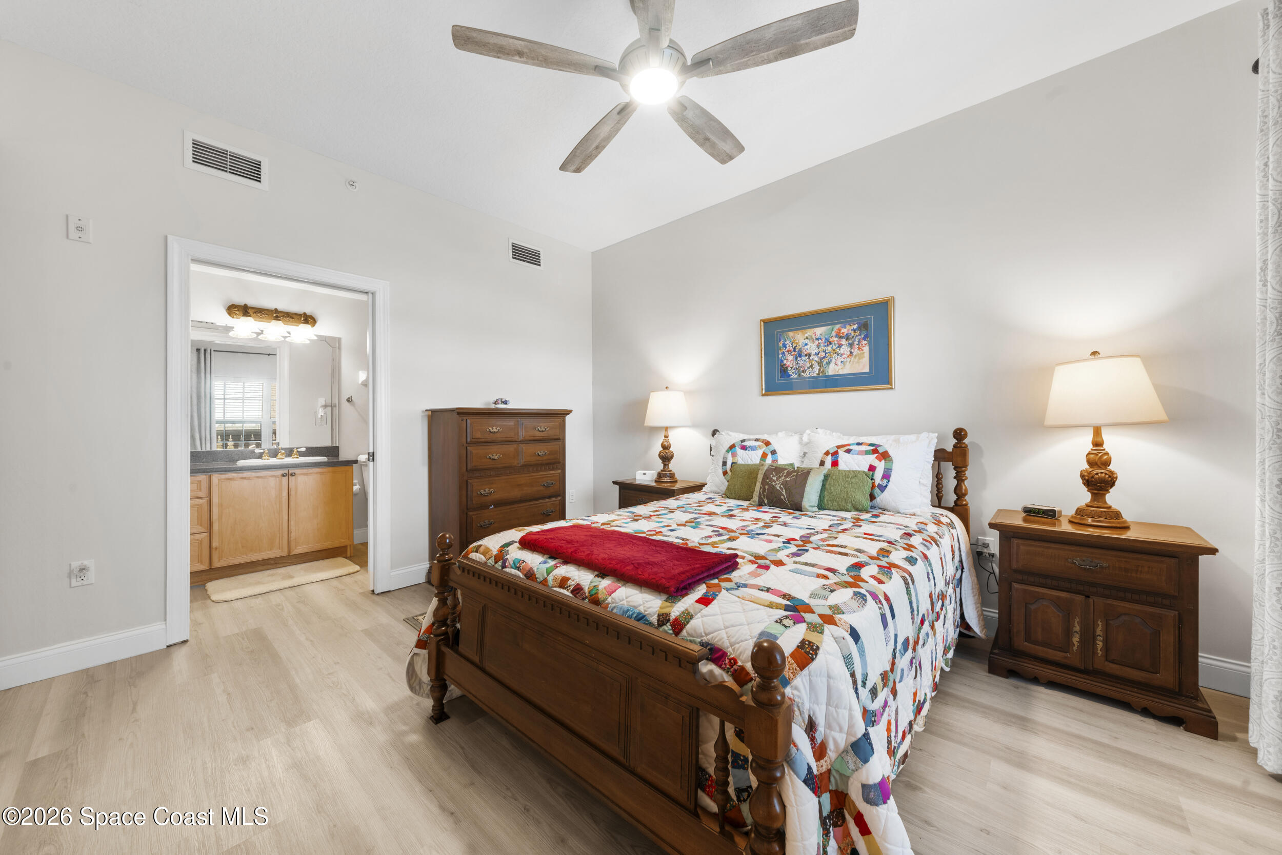 4955 Dixie Highway Northeast, Unit 702 Palm Bay, FL 32905 - Photo 10 of 54 a bedroom with a bed and a chandelier