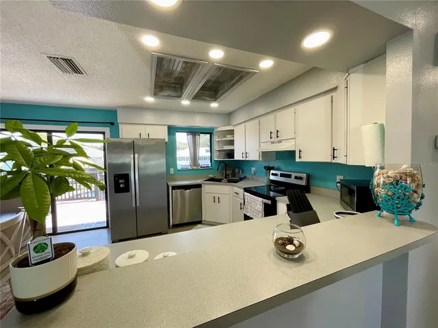 a kitchen with refrigerator and window