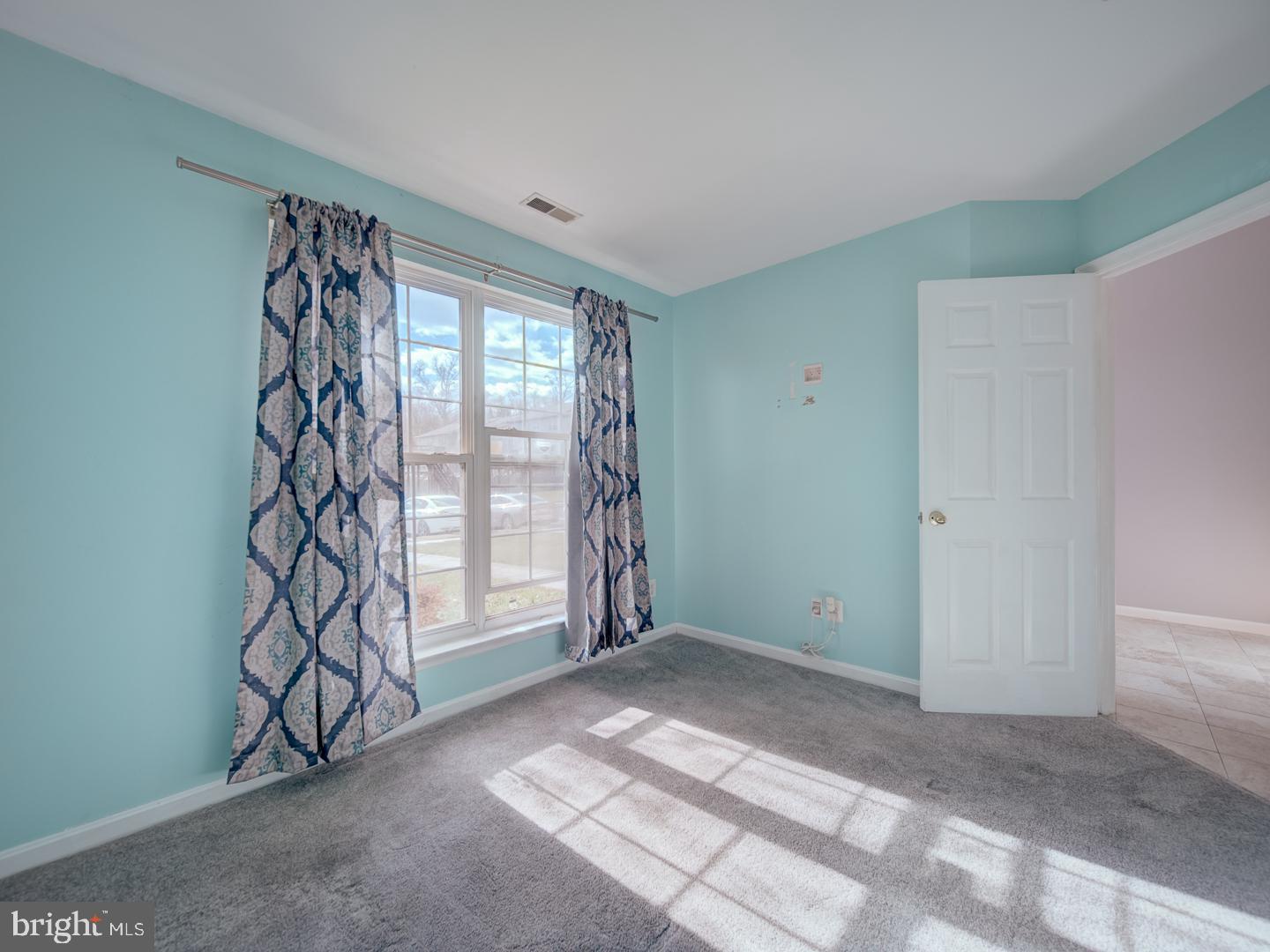 4016 Tidewood Road Baltimore, MD 21220 - Photo 11 of 40 a view of an empty room with window and stairs