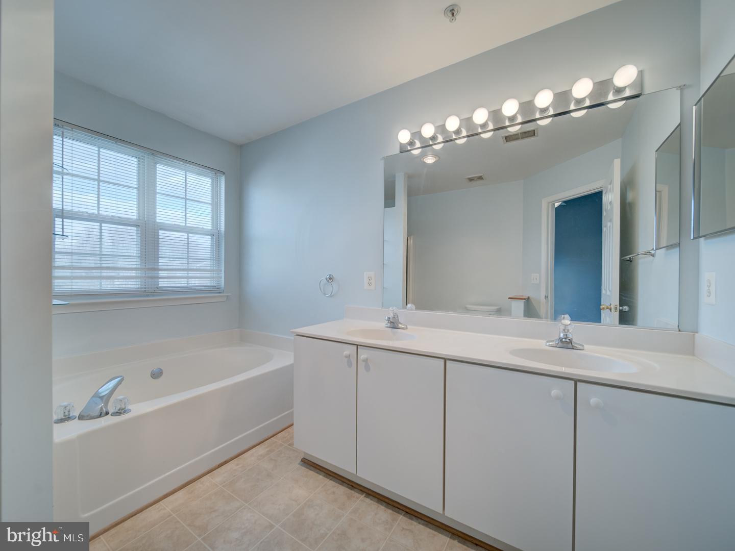 4016 Tidewood Road Baltimore, MD 21220 - Photo 14 of 40 a bathroom with a tub sink and mirror