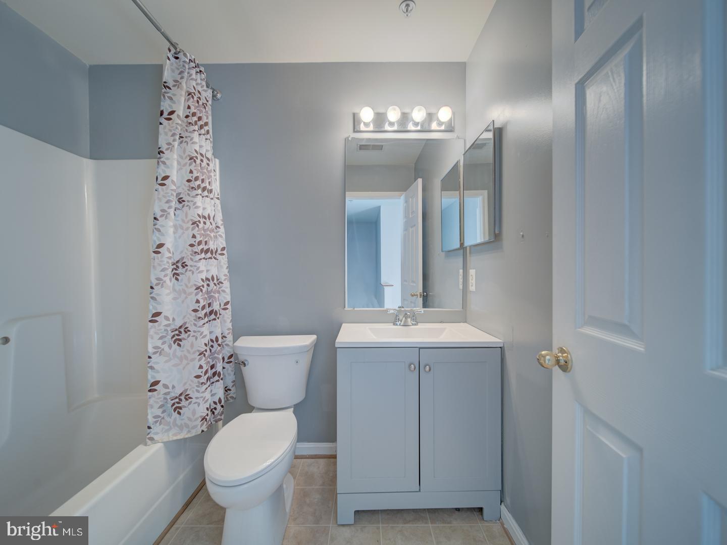 4016 Tidewood Road Baltimore, MD 21220 - Photo 18 of 40 a bathroom with a sink a toilet and a large mirror