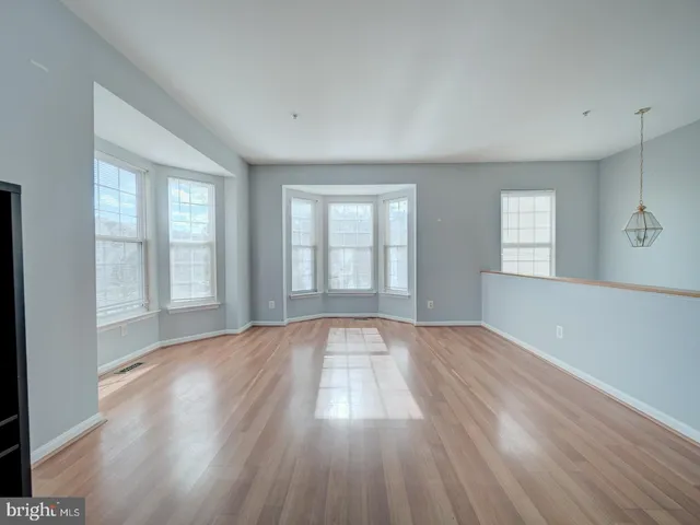 a view of an empty room and wooden floor