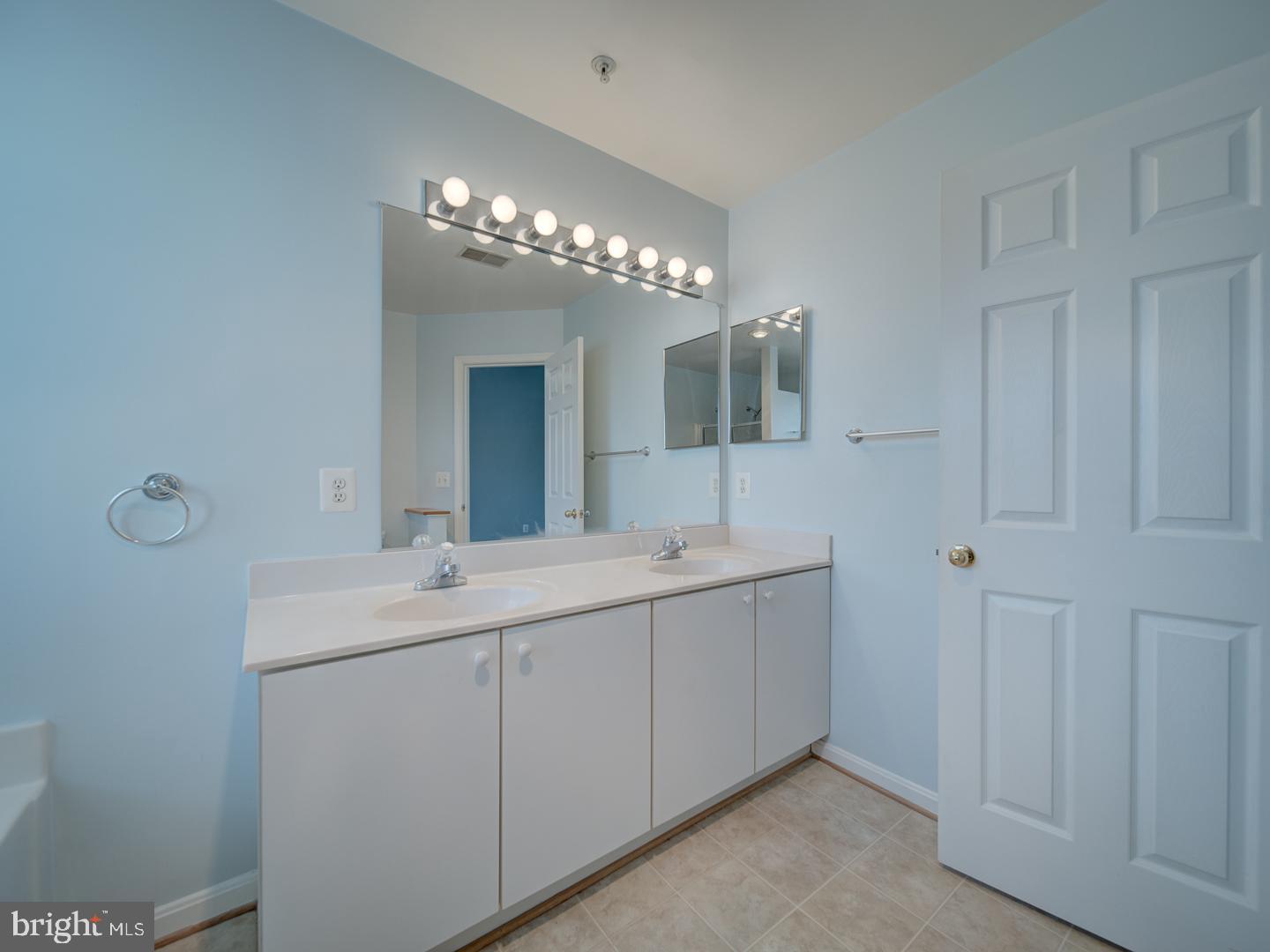 4016 Tidewood Road Baltimore, MD 21220 - Photo 32 of 40 a spacious bathroom with a double vanity sink and mirror