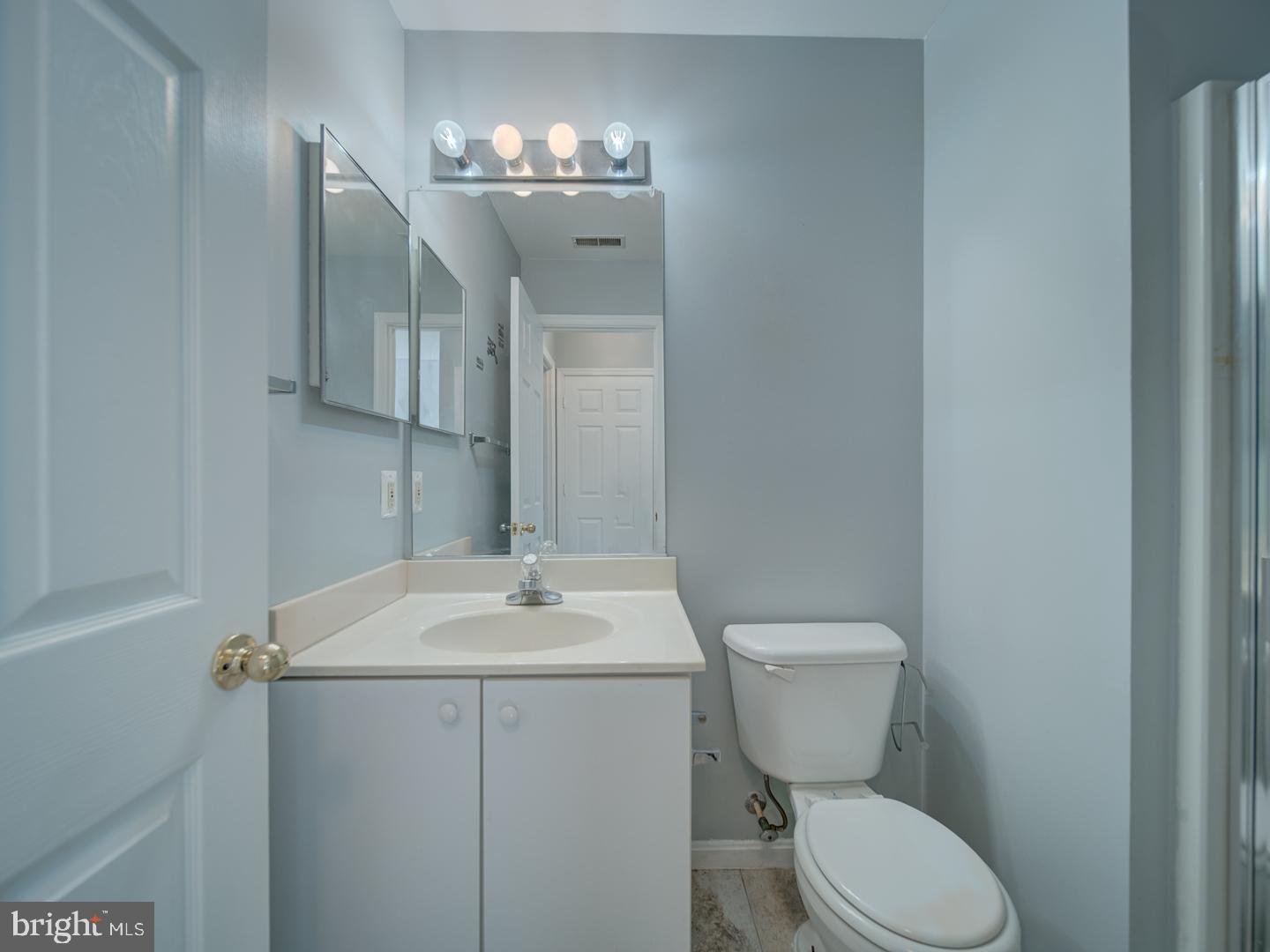 4016 Tidewood Road Baltimore, MD 21220 - Photo 10 of 40 a bathroom with a toilet sink and mirror