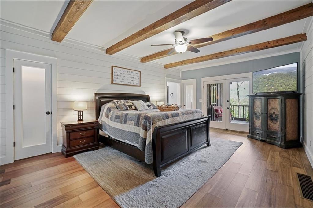 188 Tea Berry Lane Jasper, GA 30143 - Photo 22 of 68 a spacious bedroom with a bed and wooden floor